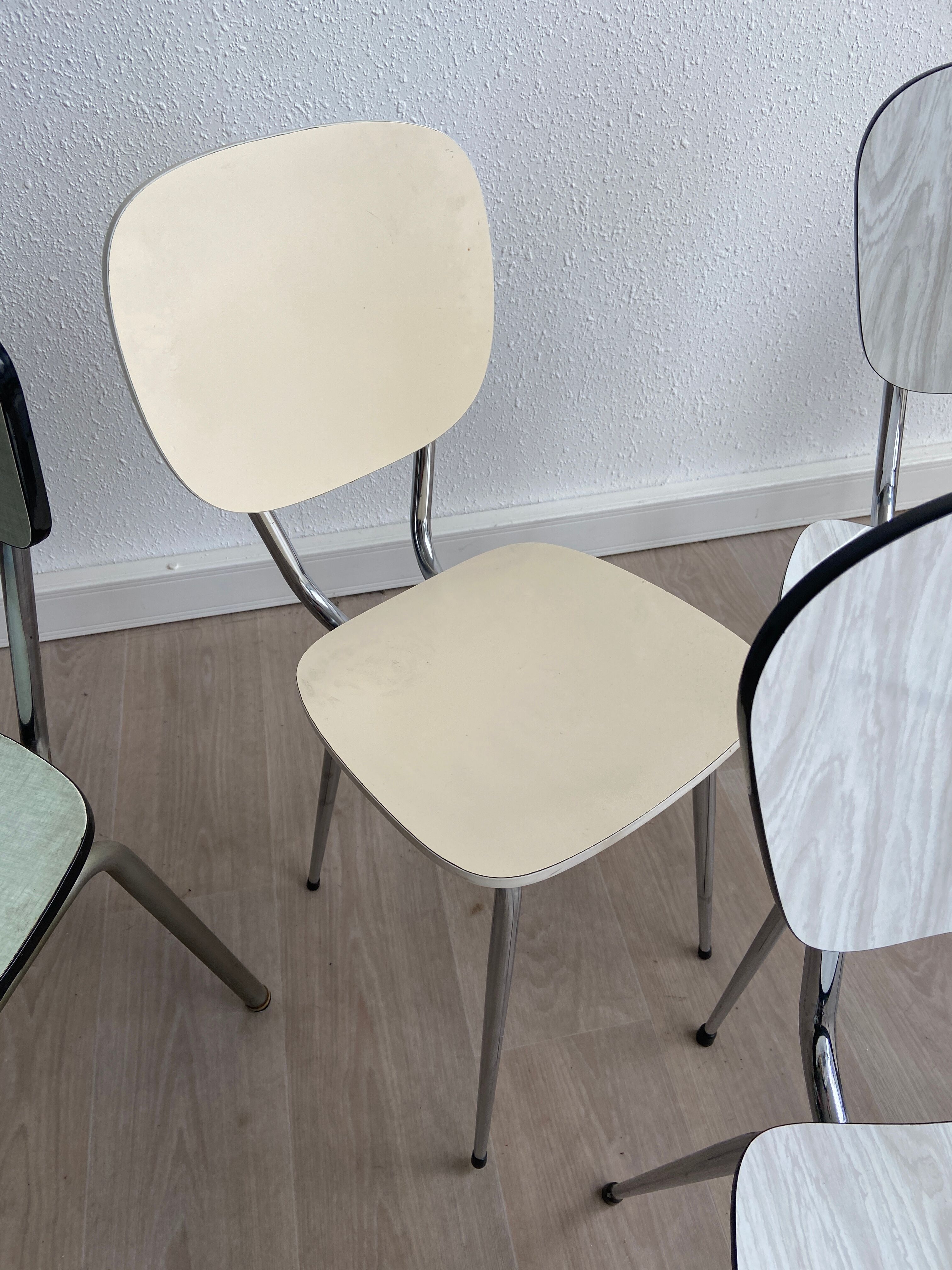 10 mismatched multicolored Formica chairs 60s