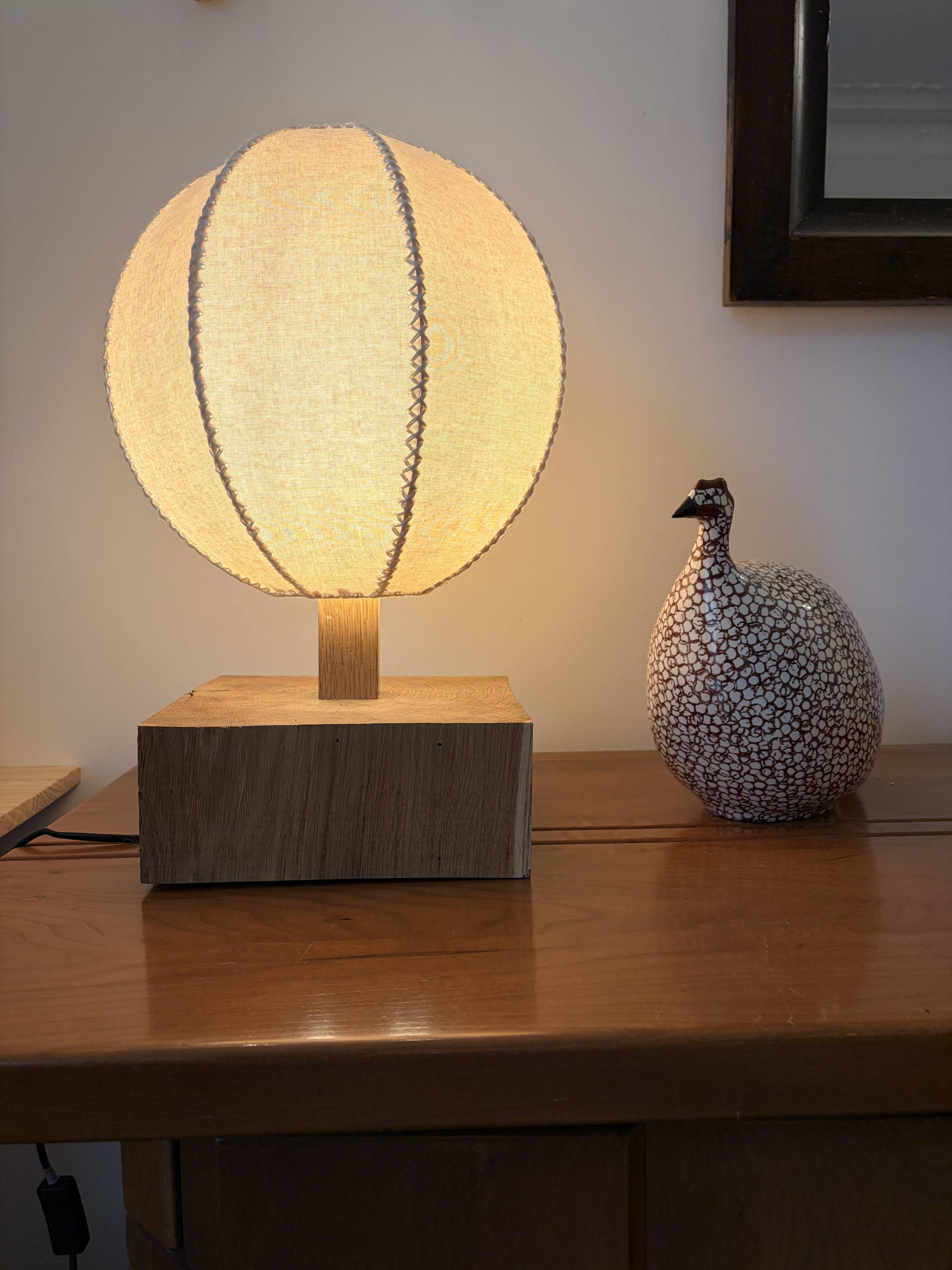 Handmade wooden ball lamp on a stand