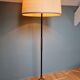 Vintage tripod floor lamp in black lacquered metal and brass, 50s