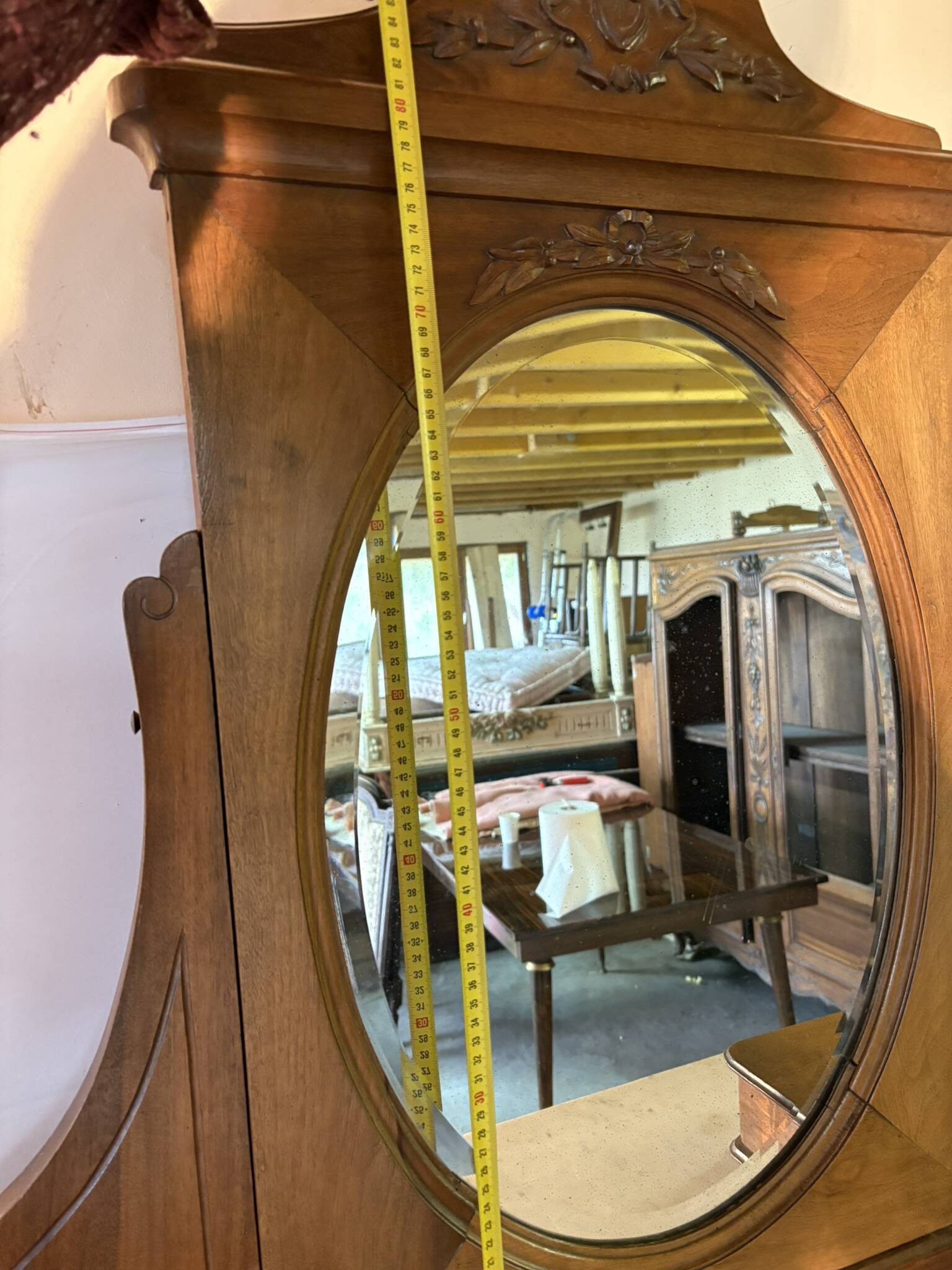 Antique carved wooden dressing table with marble and tilting oval mirror.