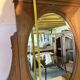 Antique carved wooden dressing table with marble and tilting oval mirror.
