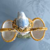 Antique earthenware salt cellar with a woman with baskets