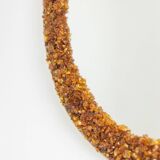 Circular and backlit mirror in amber. Contemporary artist's work.