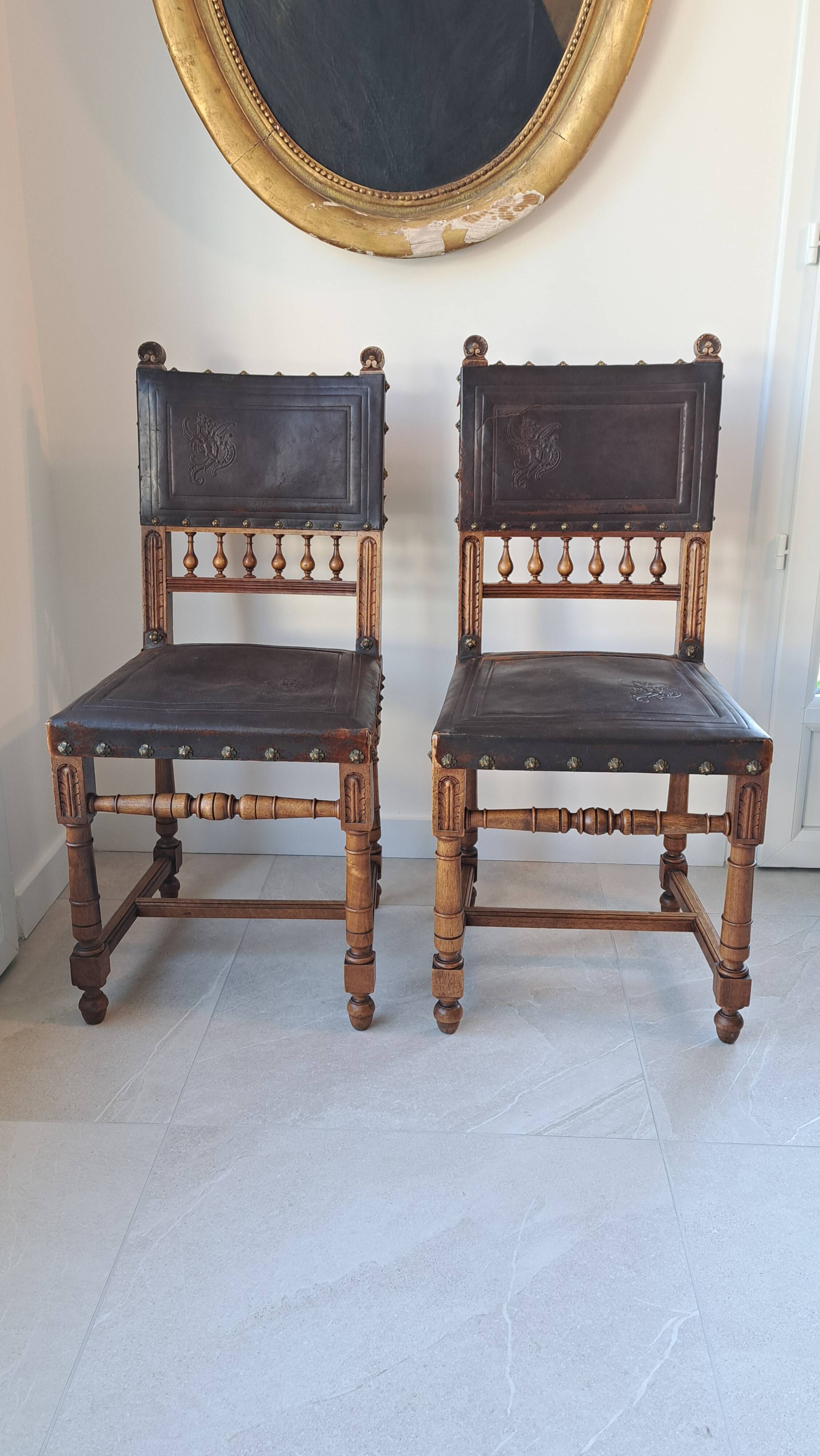 Pair of antique chairs in embossed leather, Henri II style.
