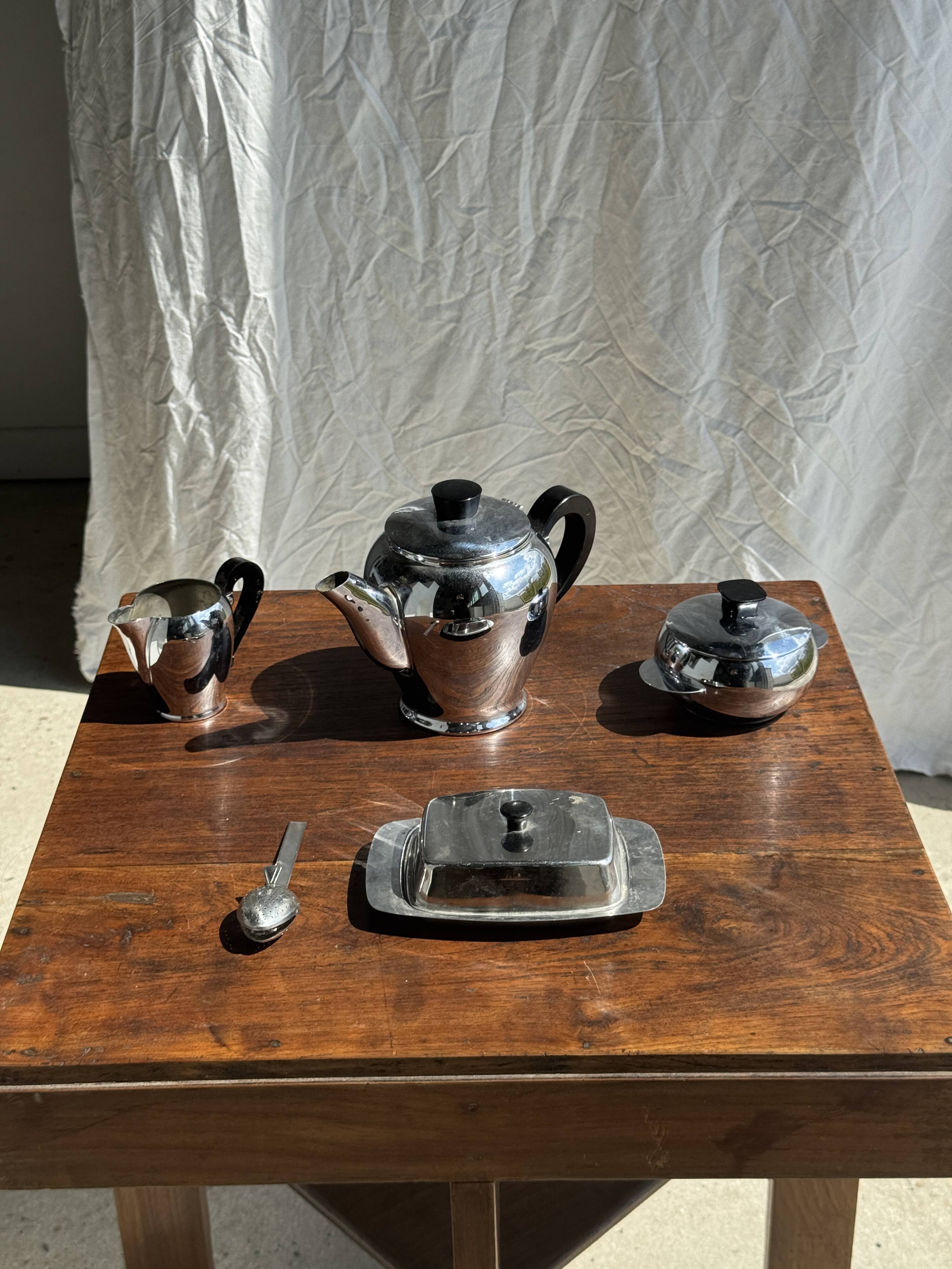 Tea set including teapot, milk jug, sugar bowl and butter dish