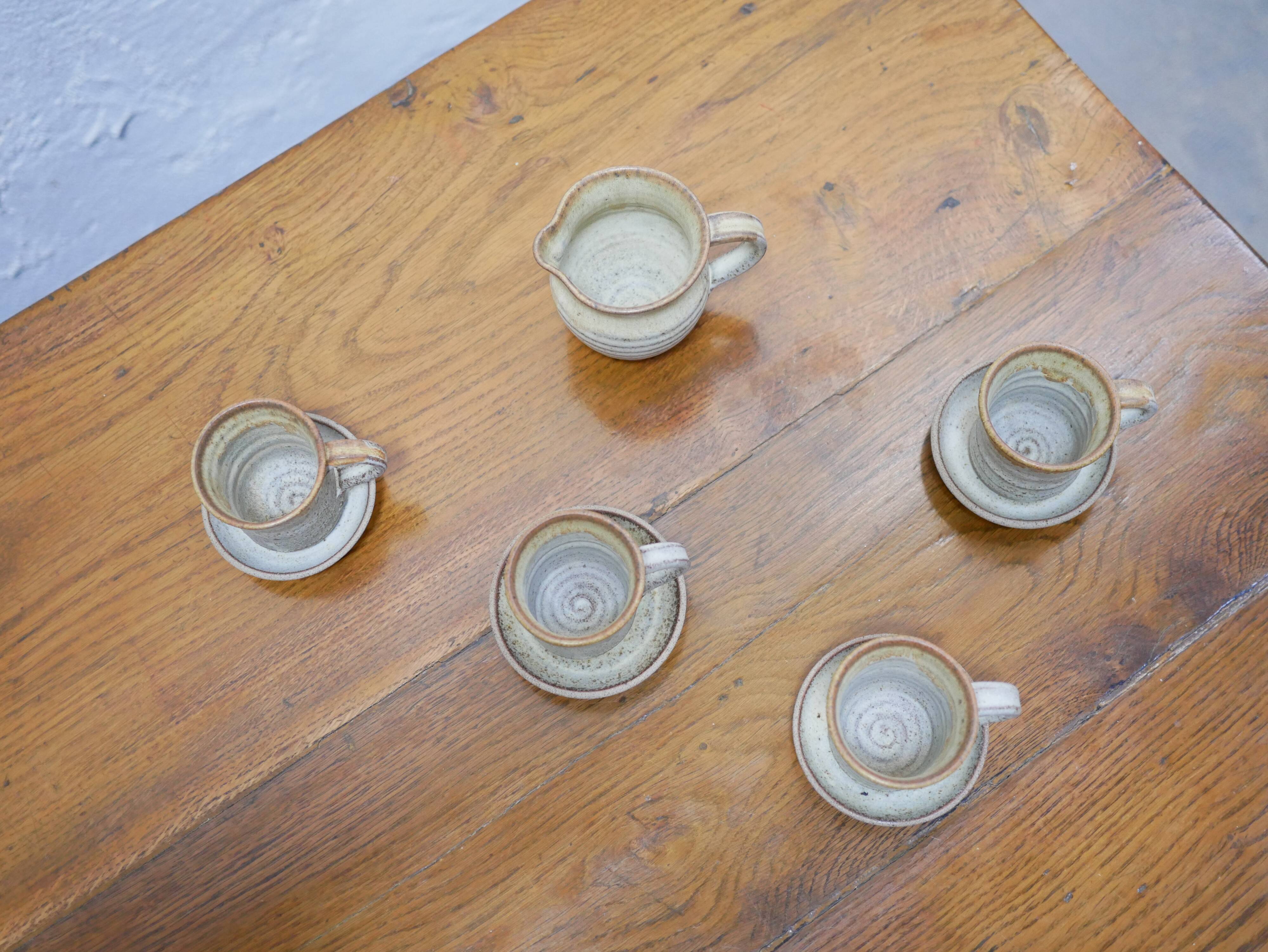 Series of 4 cups and a vintage stoneware milk jug