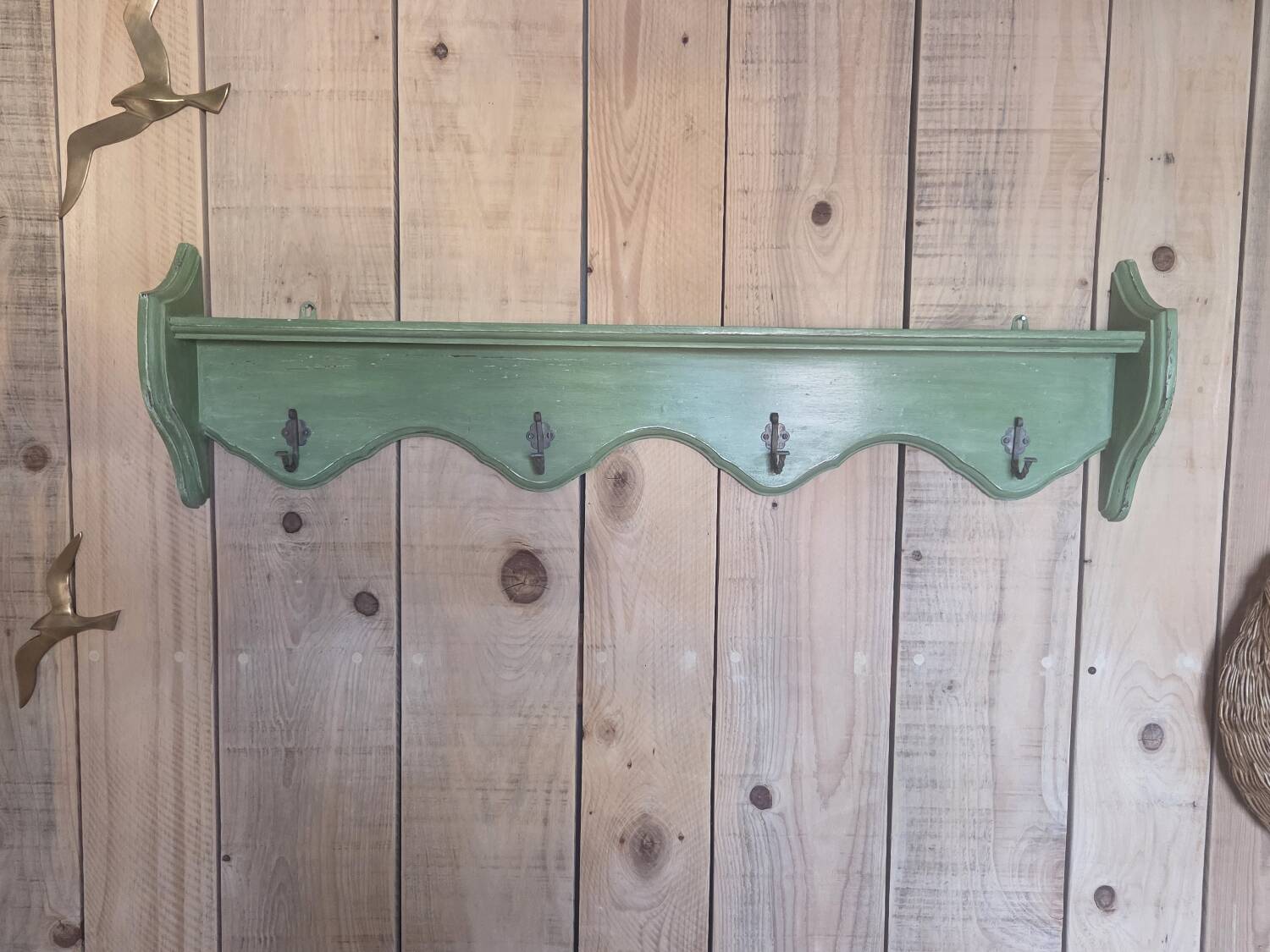 Antique wall shelf with a green patina