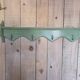Antique wall shelf with a green patina