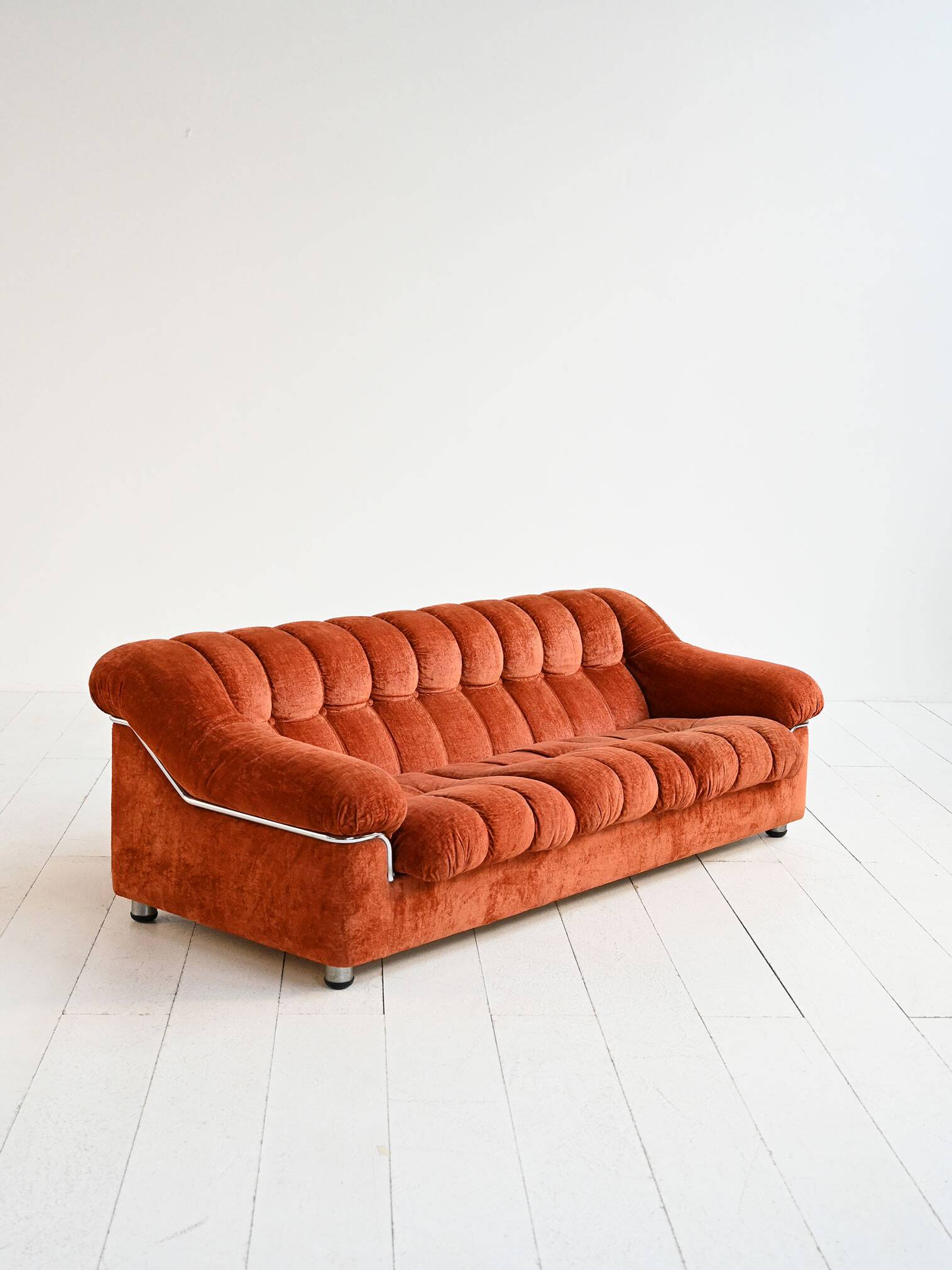 Vintage rust velvet sofa from the 1970s with metal details.