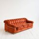 Vintage rust velvet sofa from the 1970s with metal details.