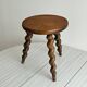 Small antique tripod stool in dark wood.