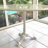 Round marble table with central cast iron leg