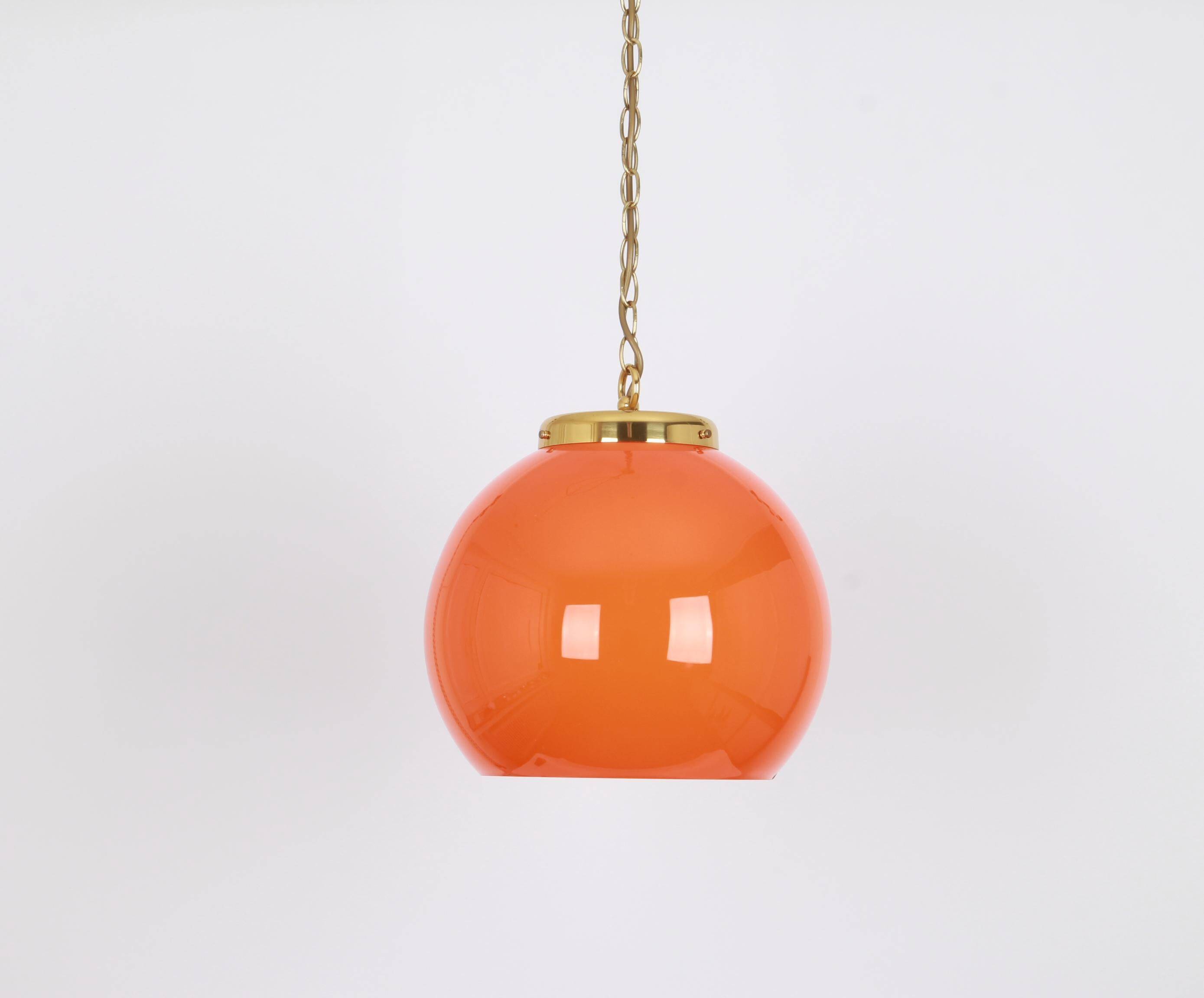 Orange glass pendant light by Peill Putzler, Germany, 1970.