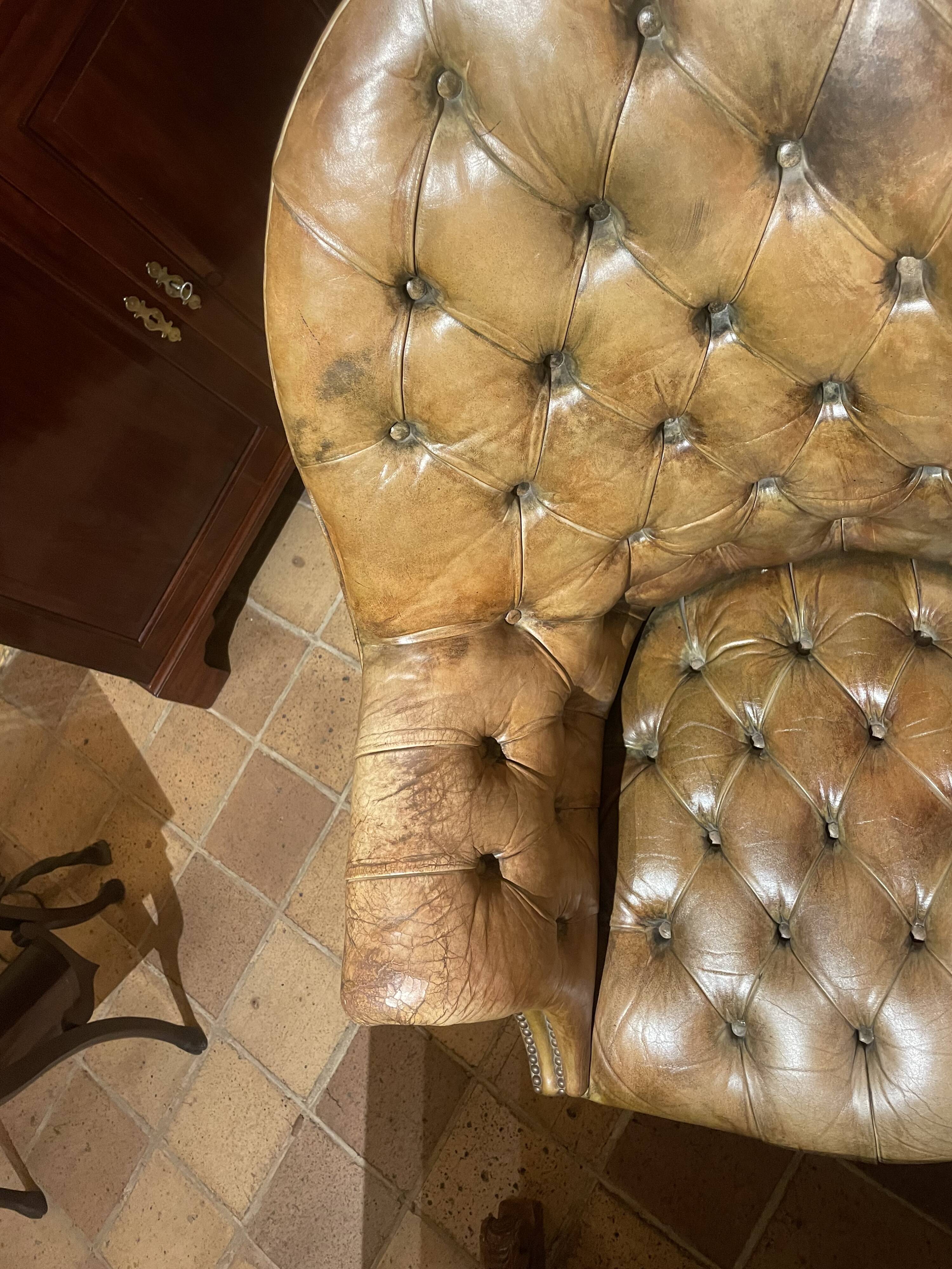 Office chair known as a presidential chair in mahogany and cognac leather.