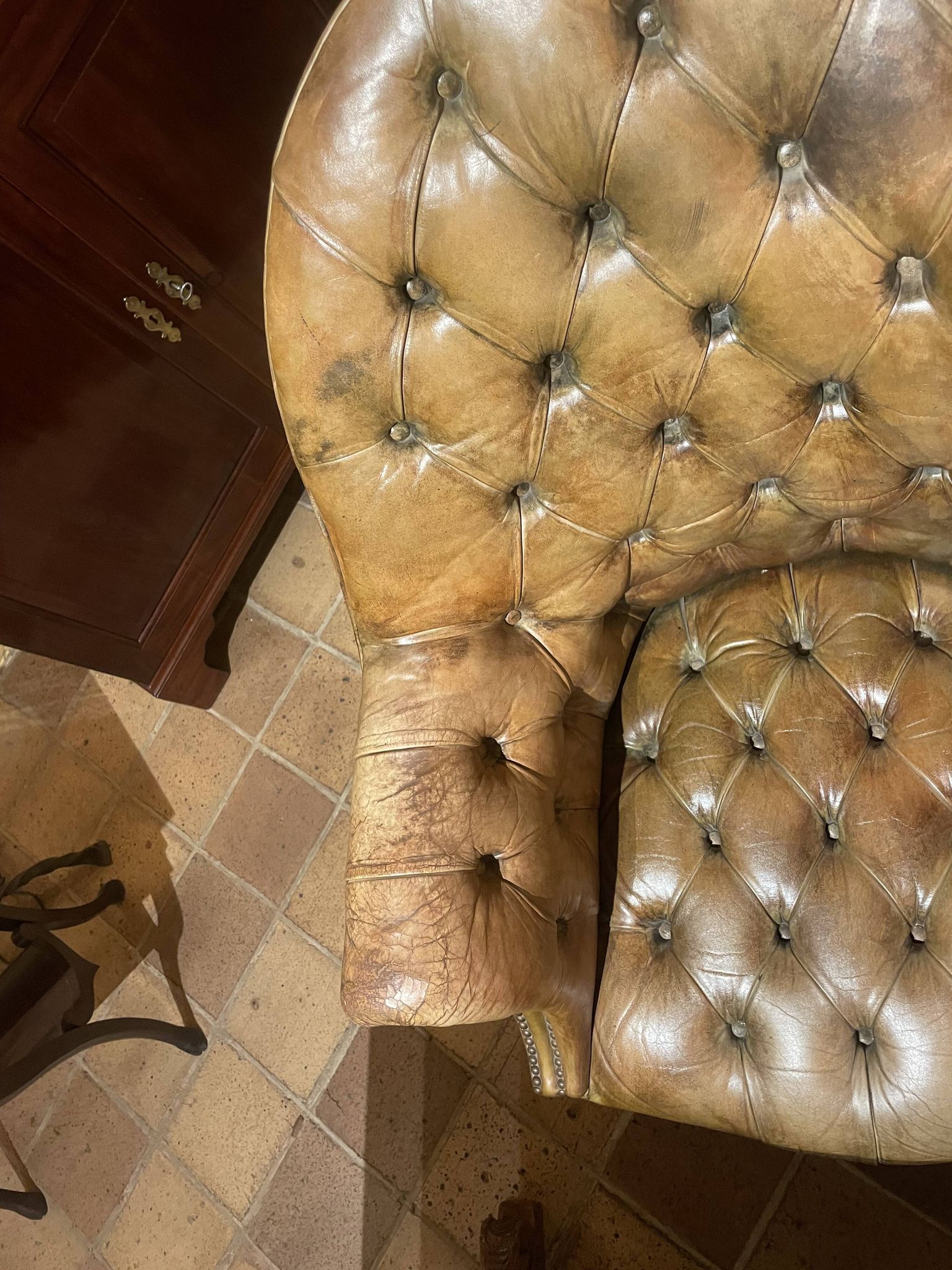 Office chair known as a presidential chair in mahogany and cognac leather.