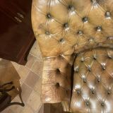 Office chair known as a presidential chair in mahogany and cognac leather.