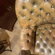 Office chair known as a presidential chair in mahogany and cognac leather.