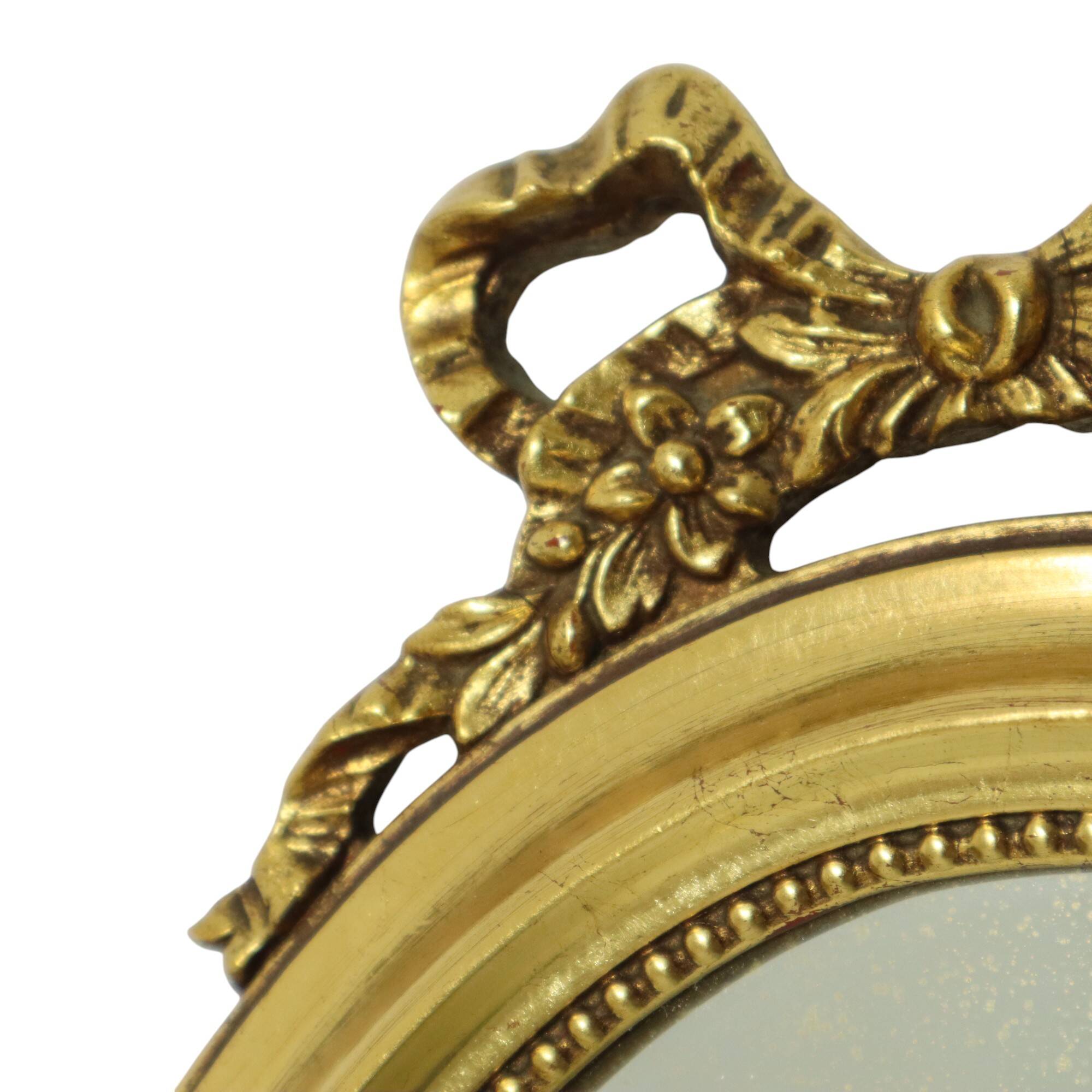 Miroir ovale classique doré à décor de ruban, France