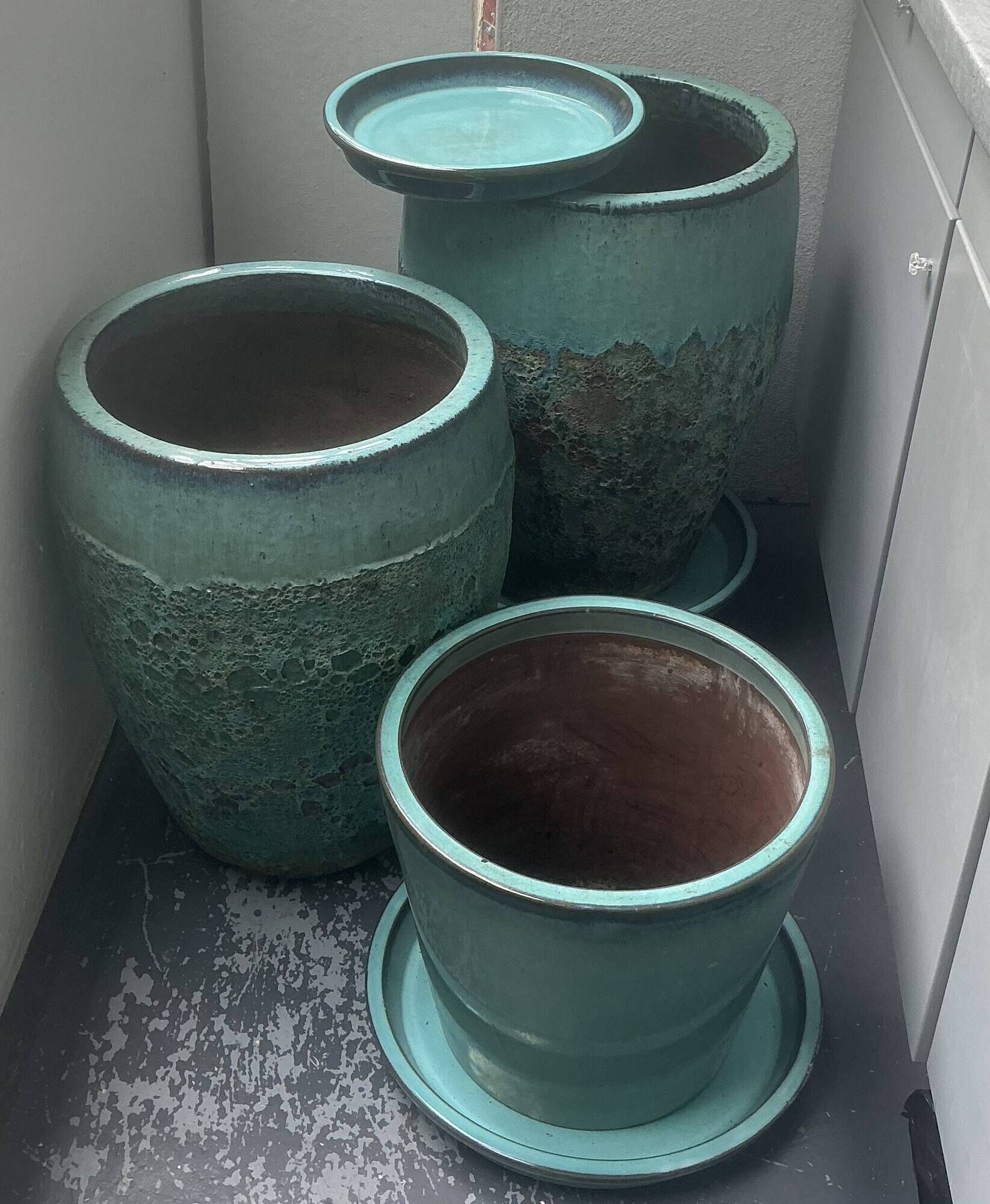 Set of 3 large blue glazed stoneware pots.