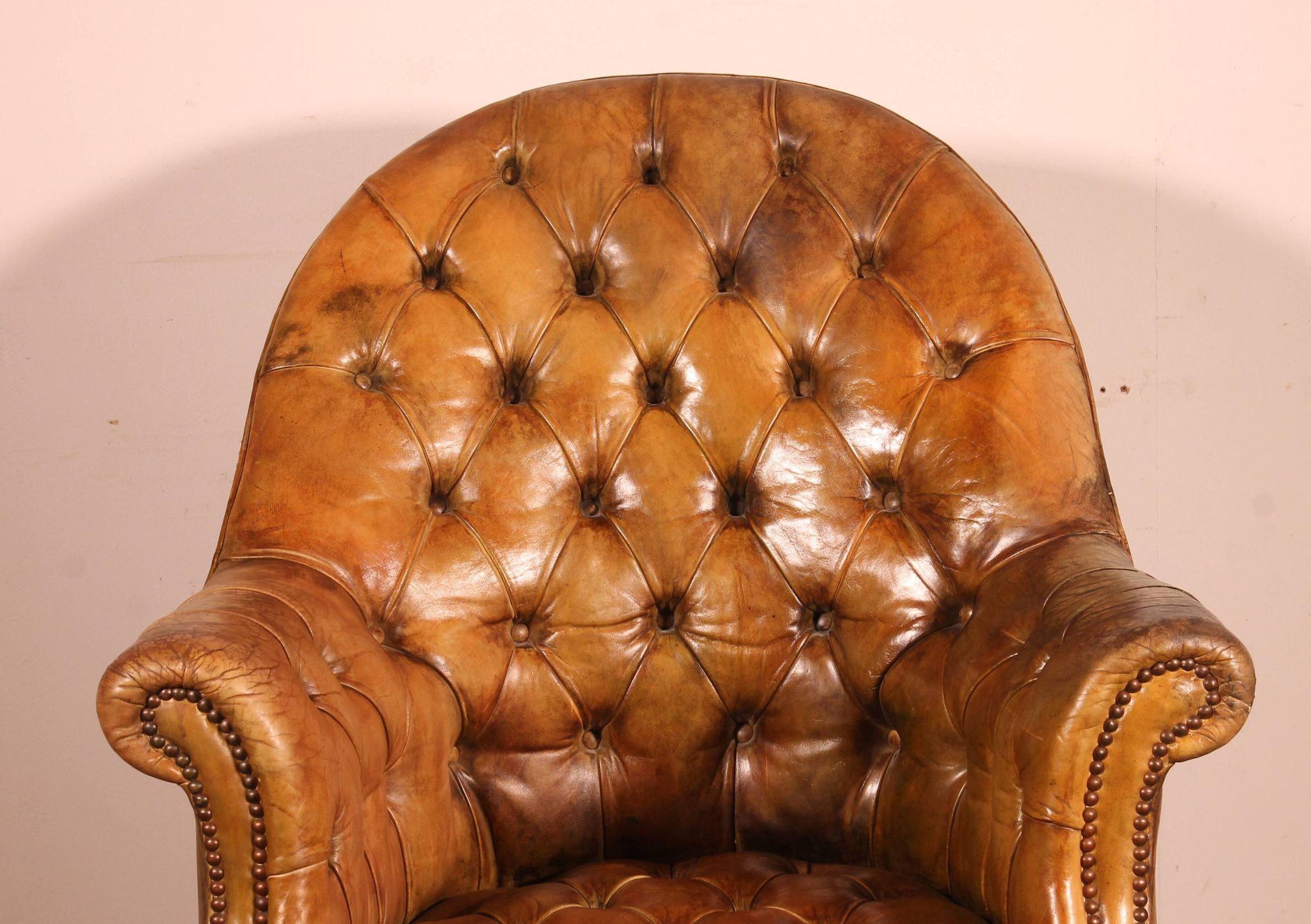 Office chair known as a presidential chair in mahogany and cognac leather.