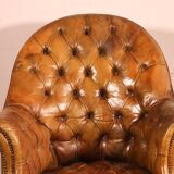 Office chair known as a presidential chair in mahogany and cognac leather.