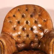 Office chair known as a presidential chair in mahogany and cognac leather.