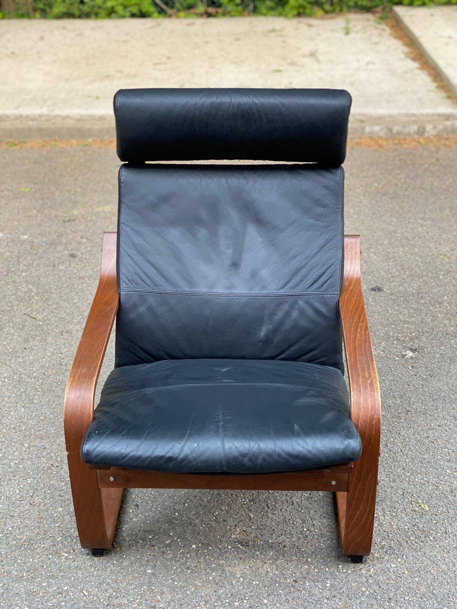 Scandinavian rocking chair in curved wood and brown leather from IKEA Poang