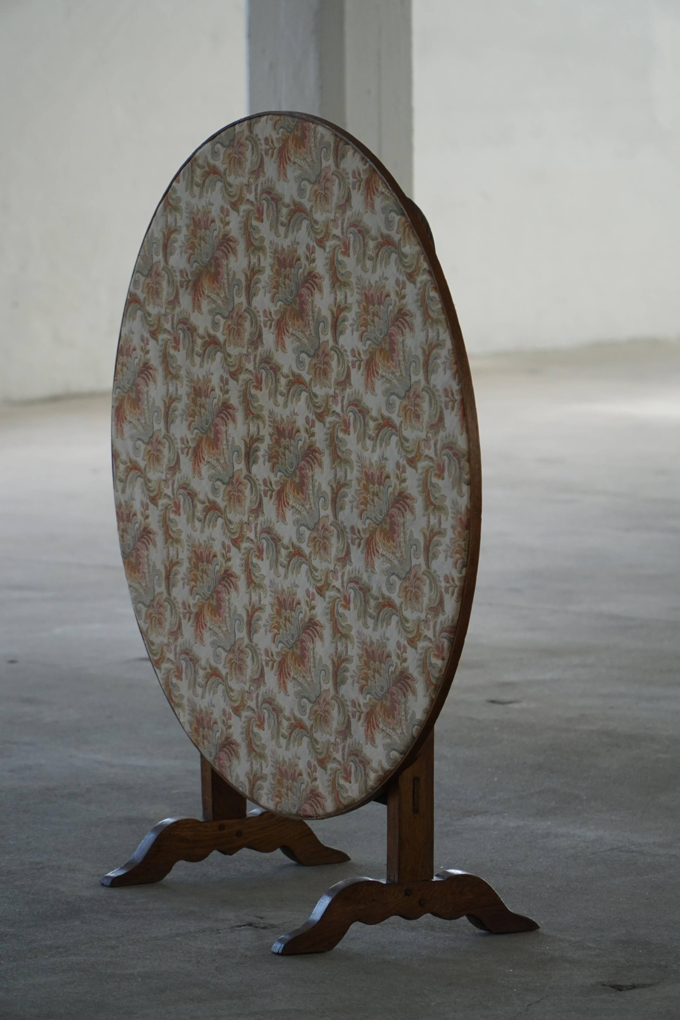 19th-century French round wine table with an adjustable top and floral textile surface.