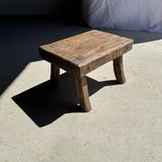 Small stool, rectangular solid teak side table with curved legs.
