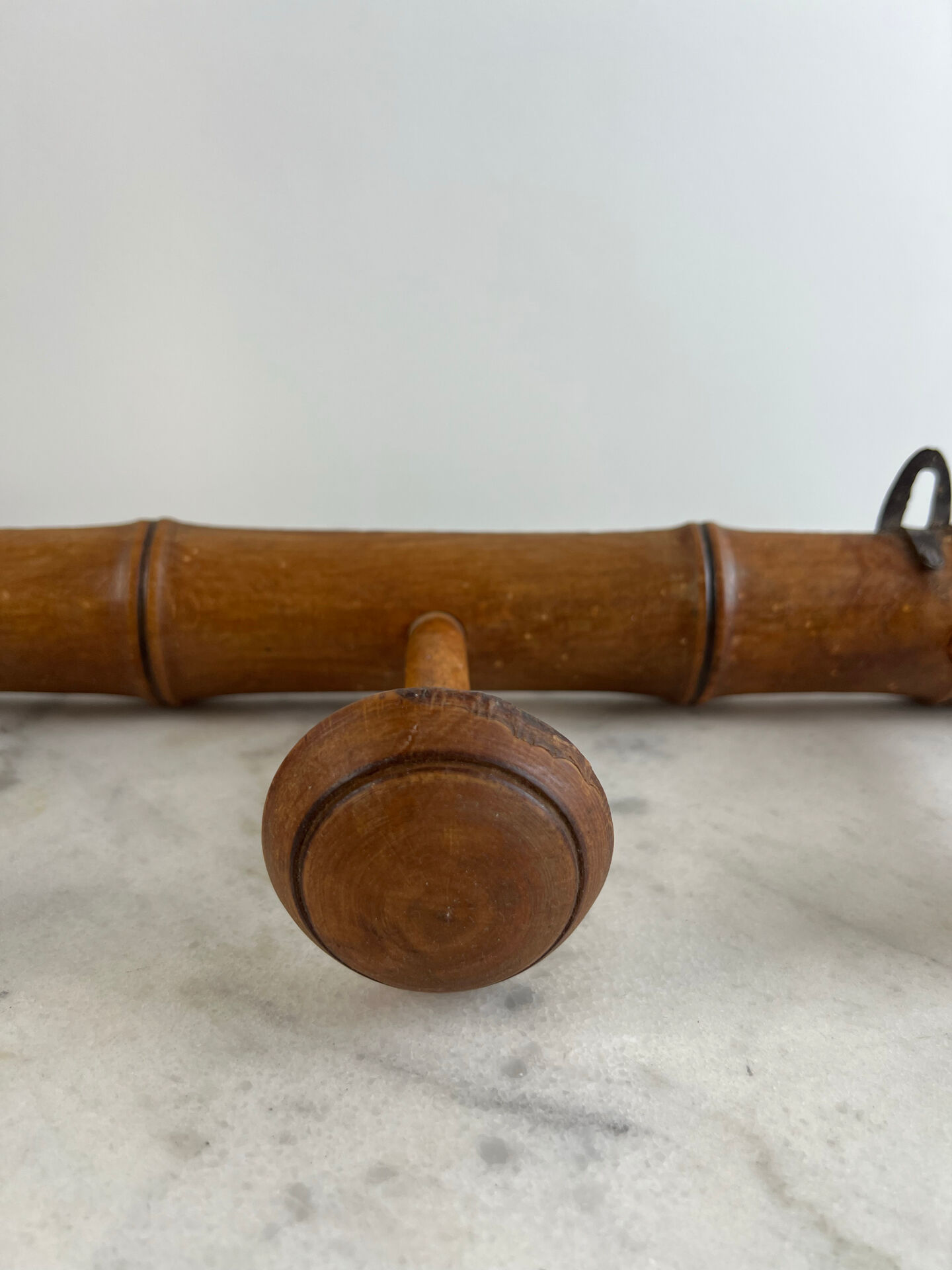 Wooden coat rack with three ball hooks.