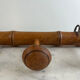 Wooden coat rack with three ball hooks.