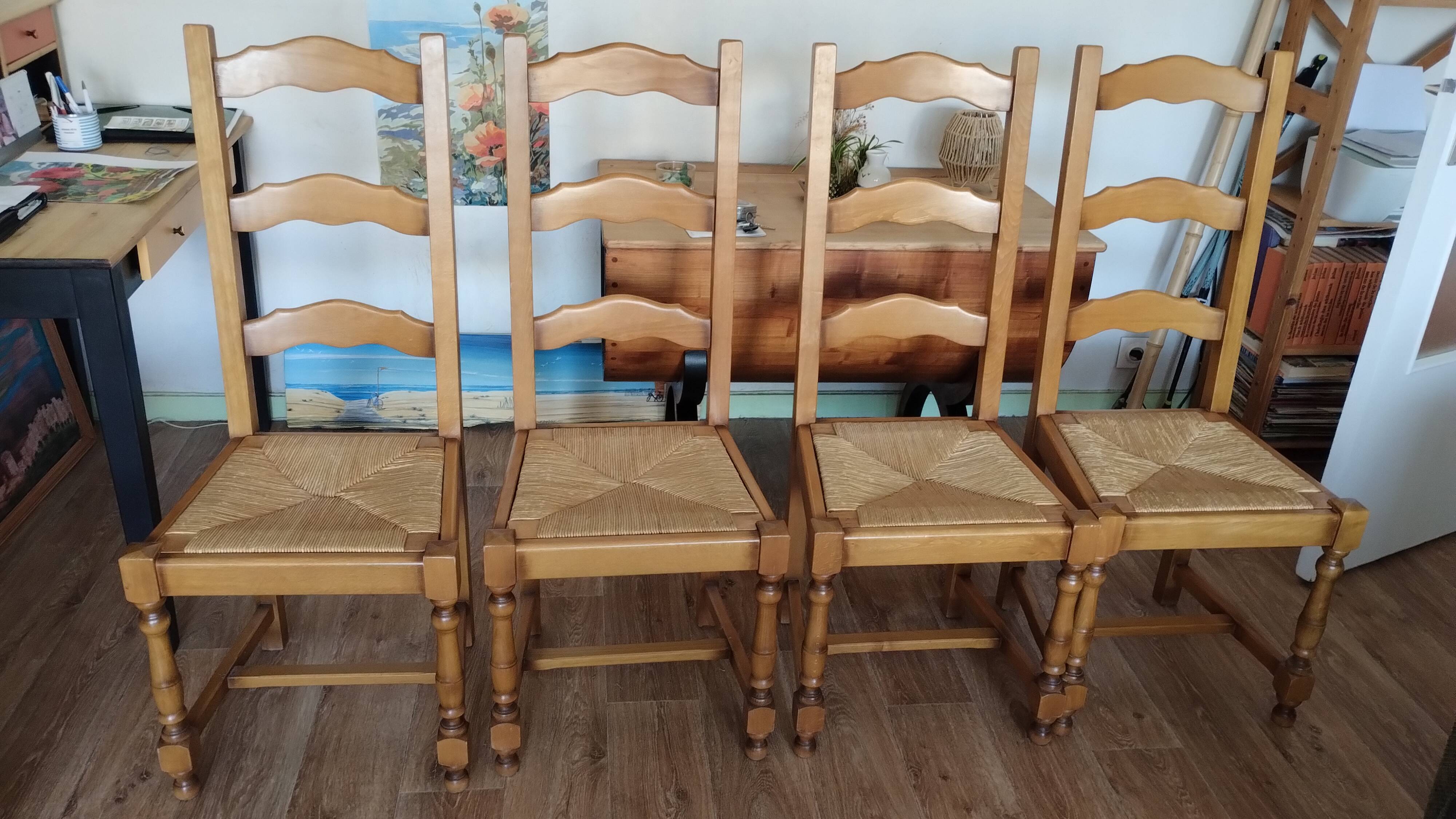 4 straw-seated solid wood chairs with high backs in rustic style.