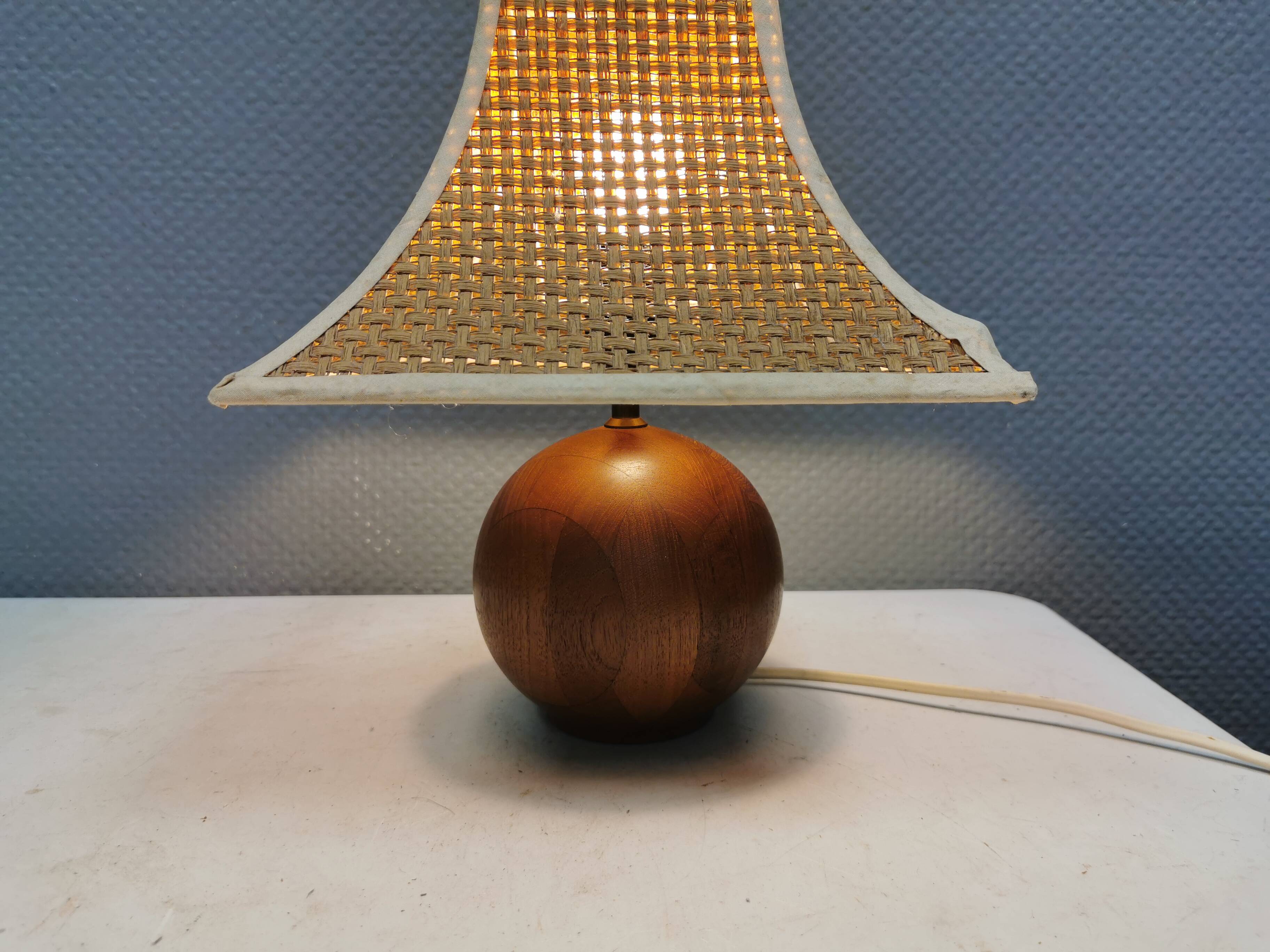 Very rare table lamp in turned teak wood with original braided shade. 1970s