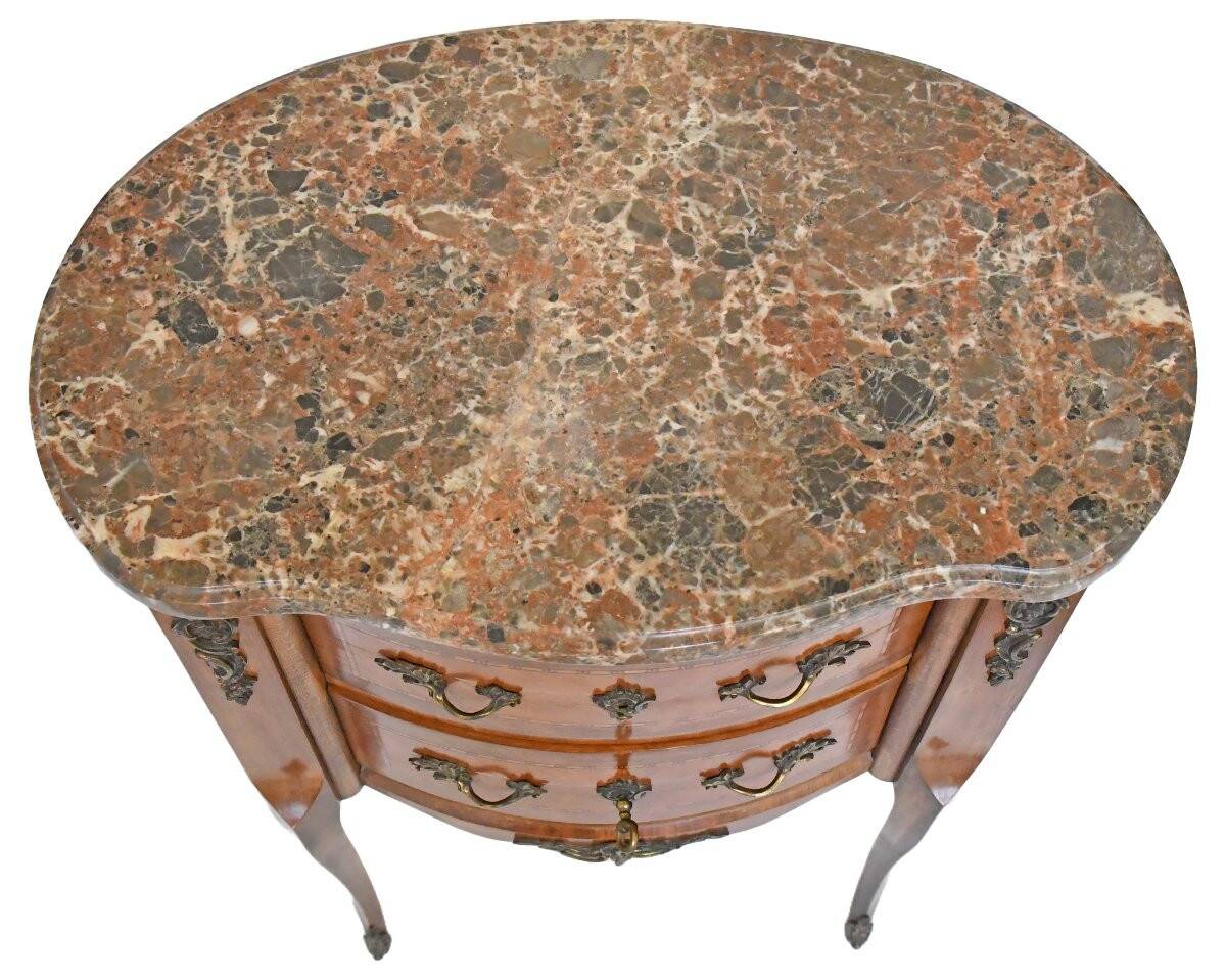 Small kidney-shaped chest of drawers in Transition style.