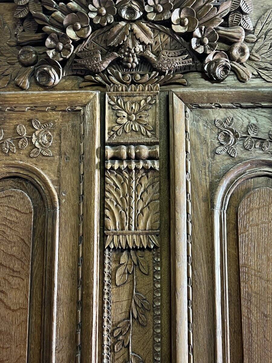 19th-century Norman wedding armoire, with bouquets of flowers and doves.