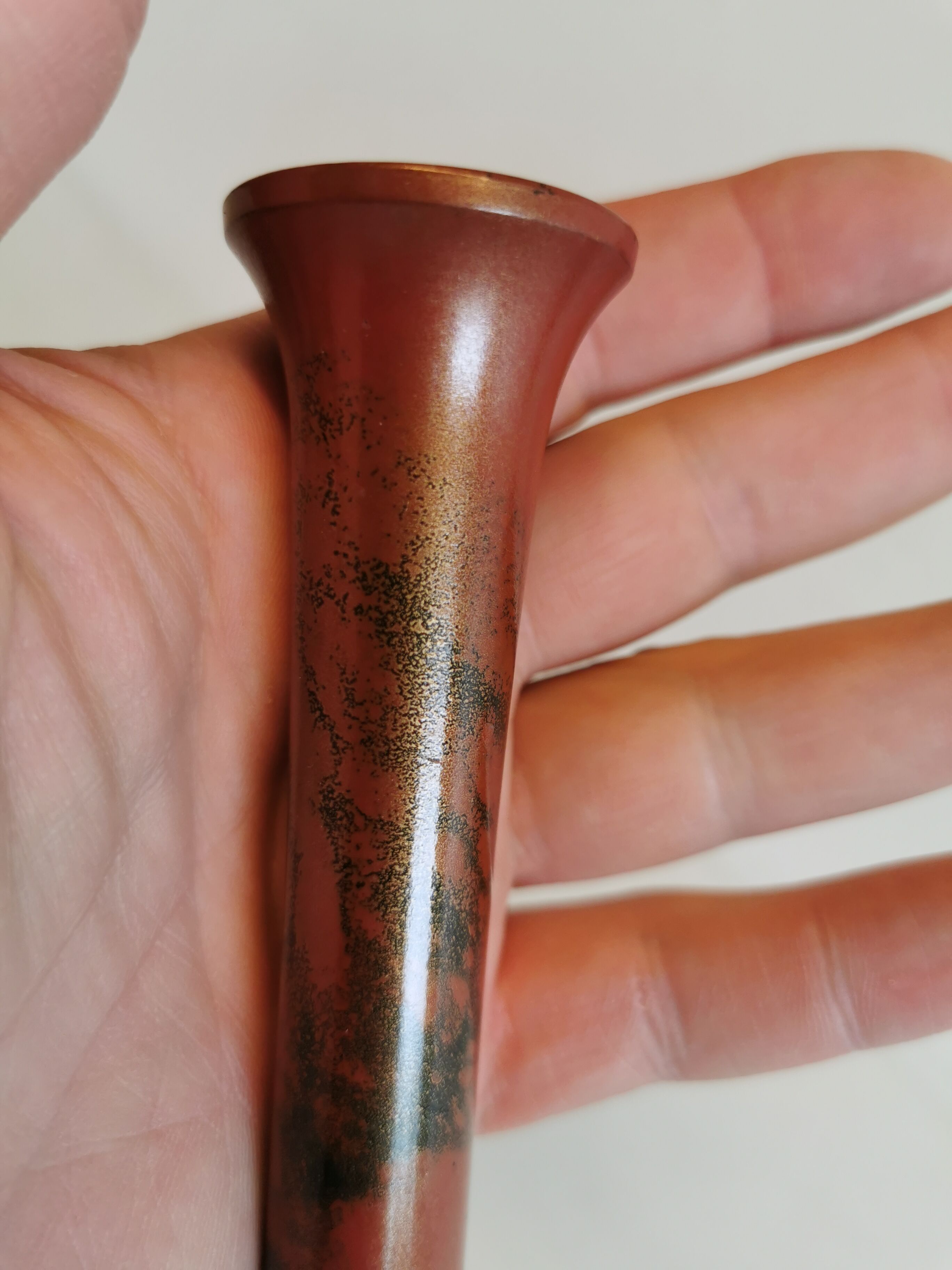 Slim vase with metallic finish.