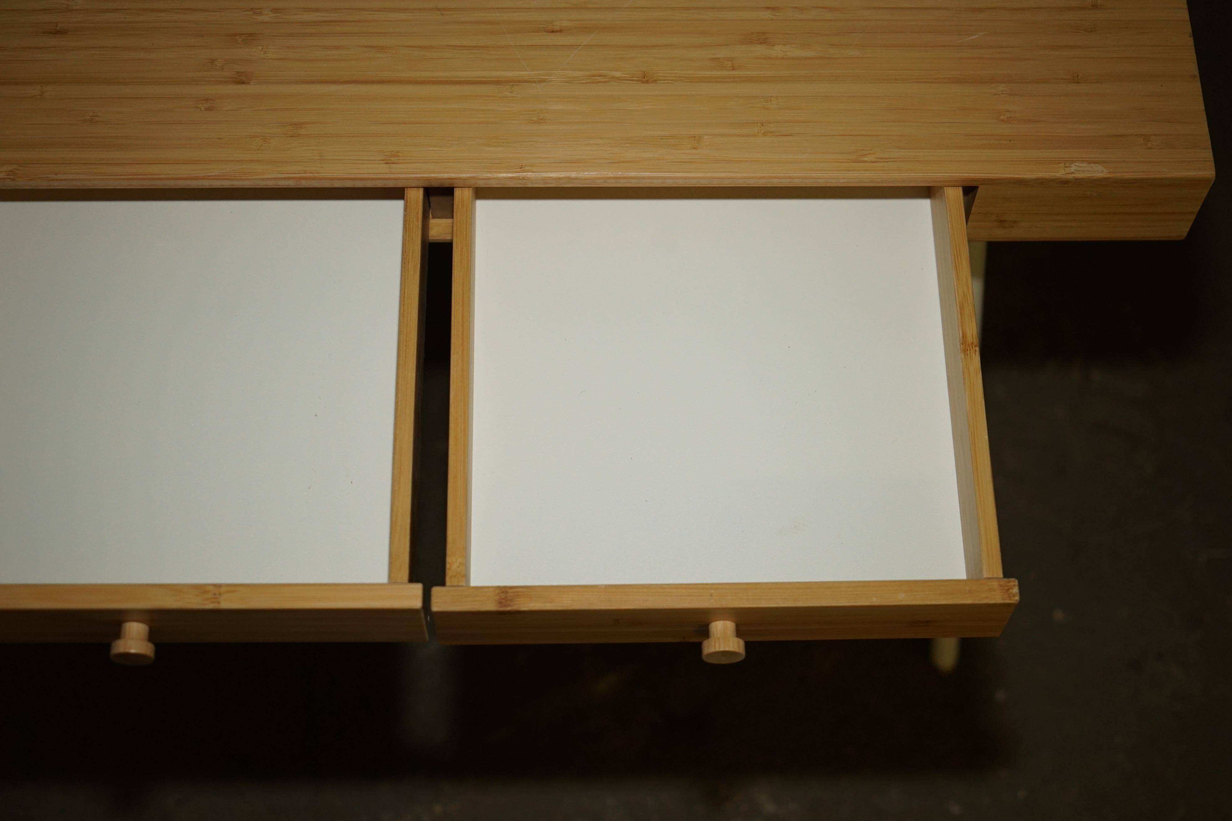 Small bamboo desk with three drawers.