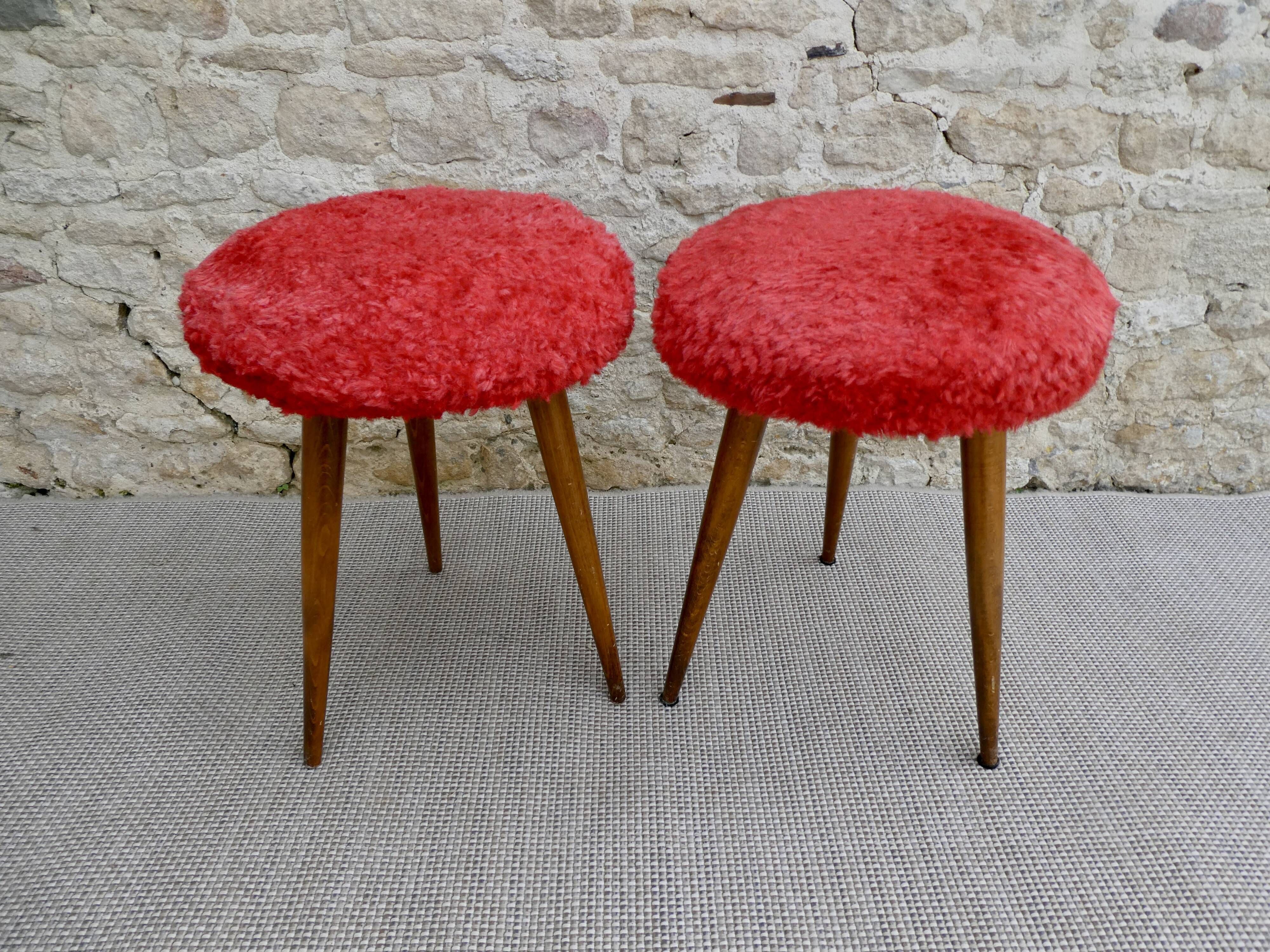 Pair of tripod stools, with tapered wooden feet and moumoute seat