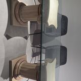 Oval glass table with marble column.