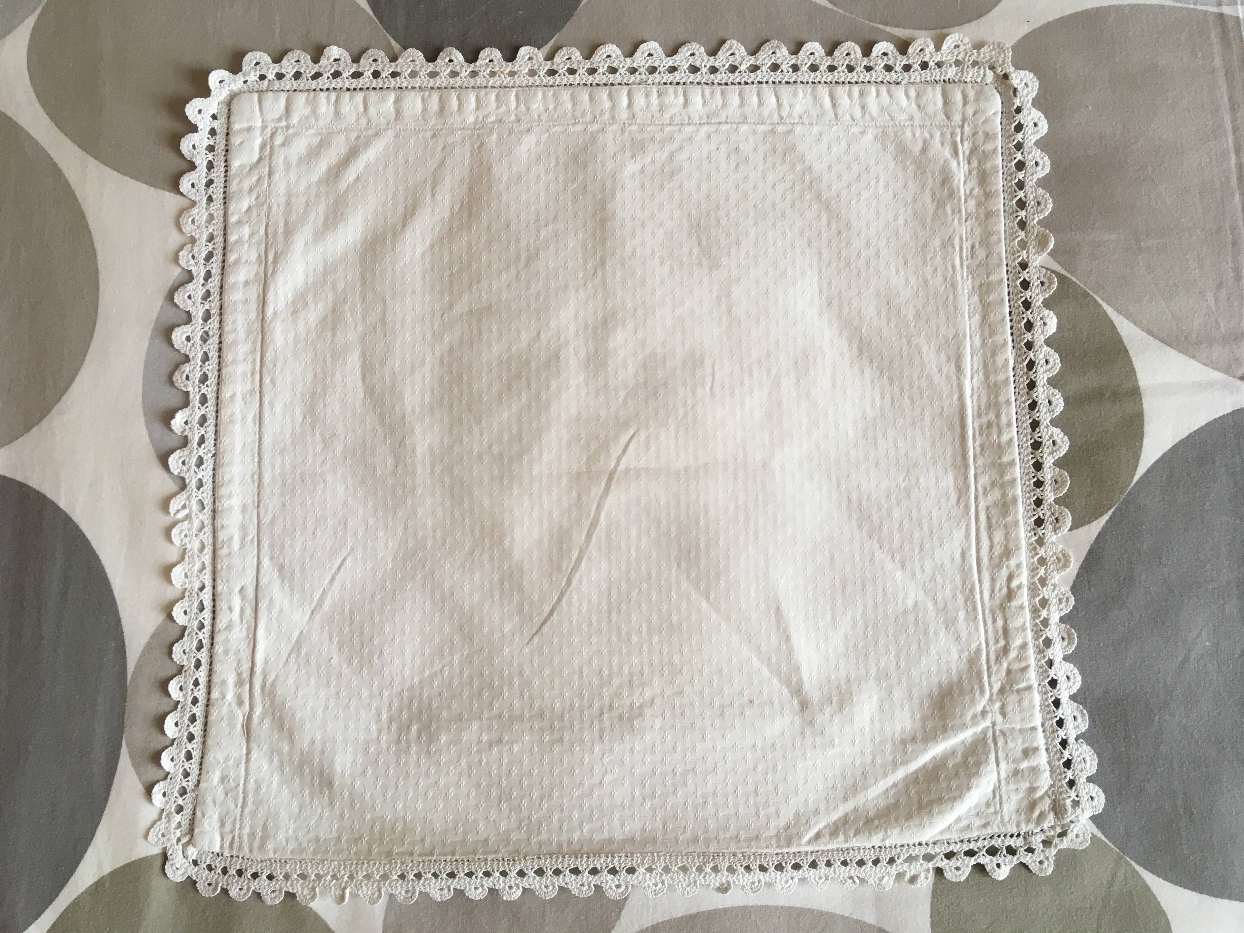 A handmade lace cushion cover