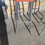 Pair of aluminum bar stools with orange and black seats