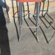 Pair of aluminum bar stools with orange and black seats