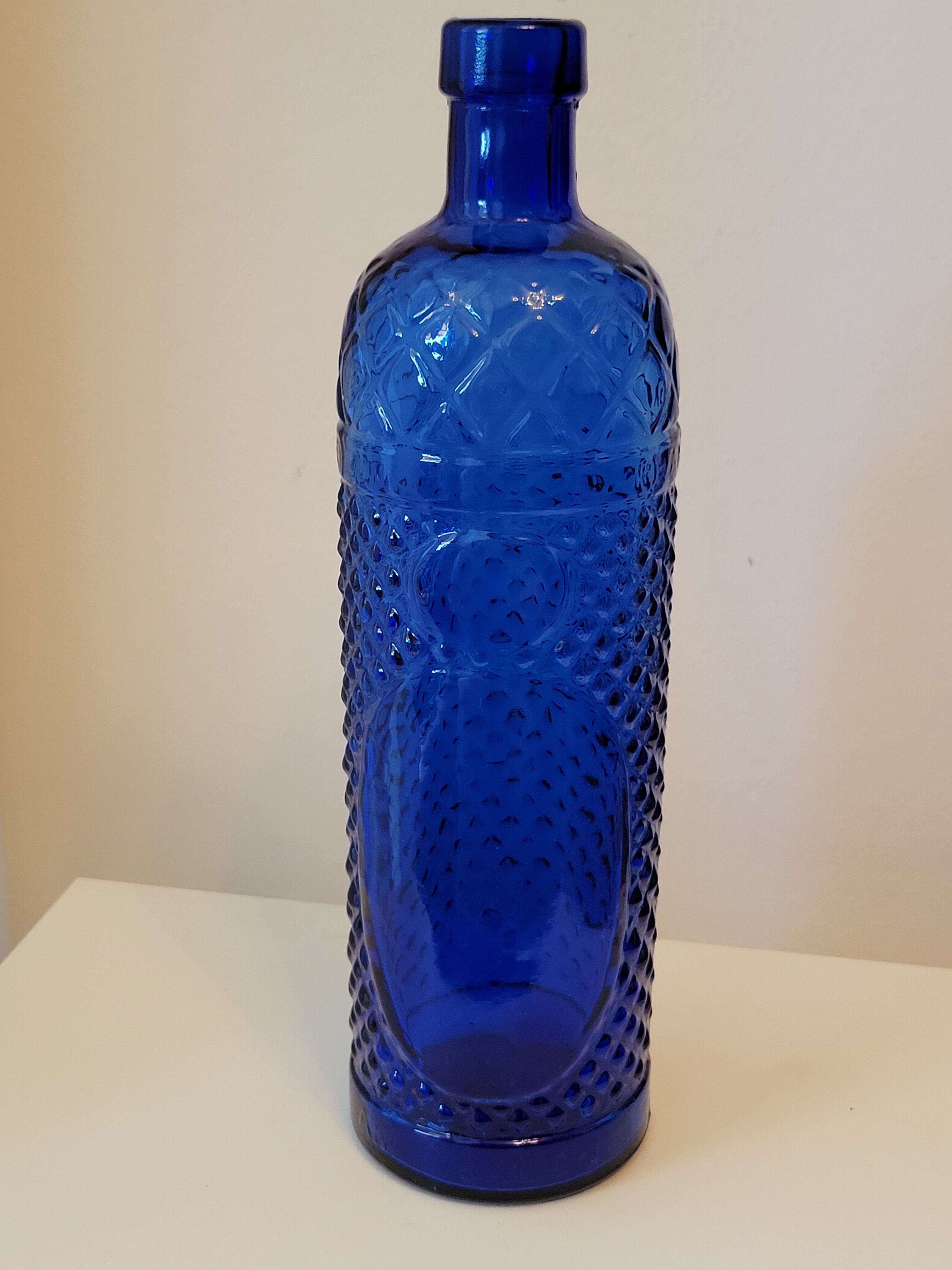 Vintage decanter bottle made of blue molded pressed glass