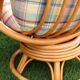Swivel rattan armchair with matching ottoman