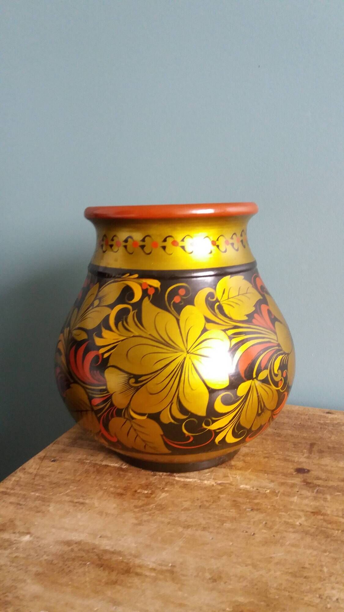 Khokhloma vase, Russian lacquered wood craftsmanship, hand-painted floral decoration.