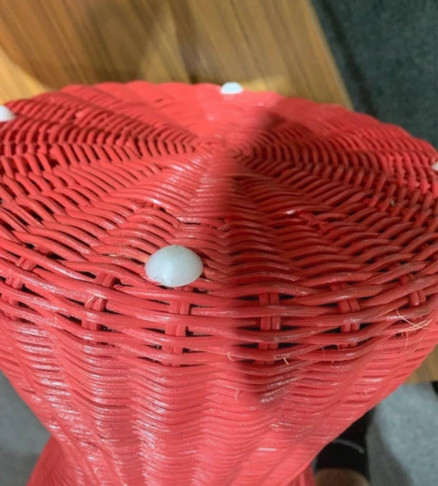 Vintage hourglass stool in red wicker or woven rattan.