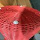 Vintage hourglass stool in red wicker or woven rattan.
