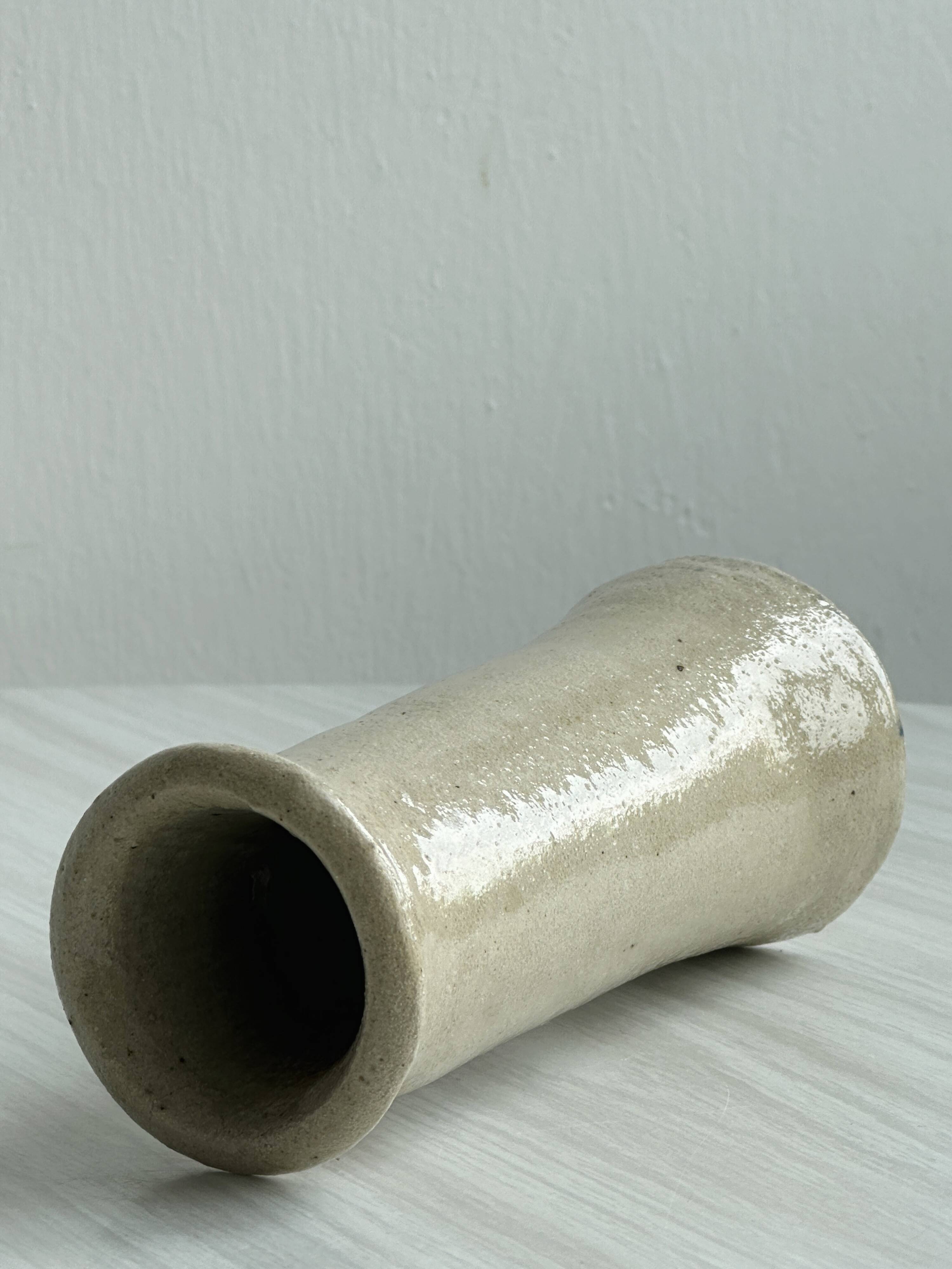 Minimalist beige ceramic vase.