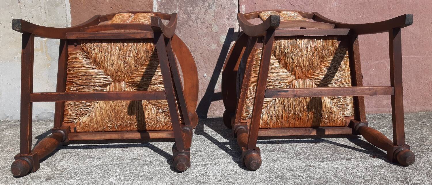 Pair of oak armchairs with straw seats and backs.