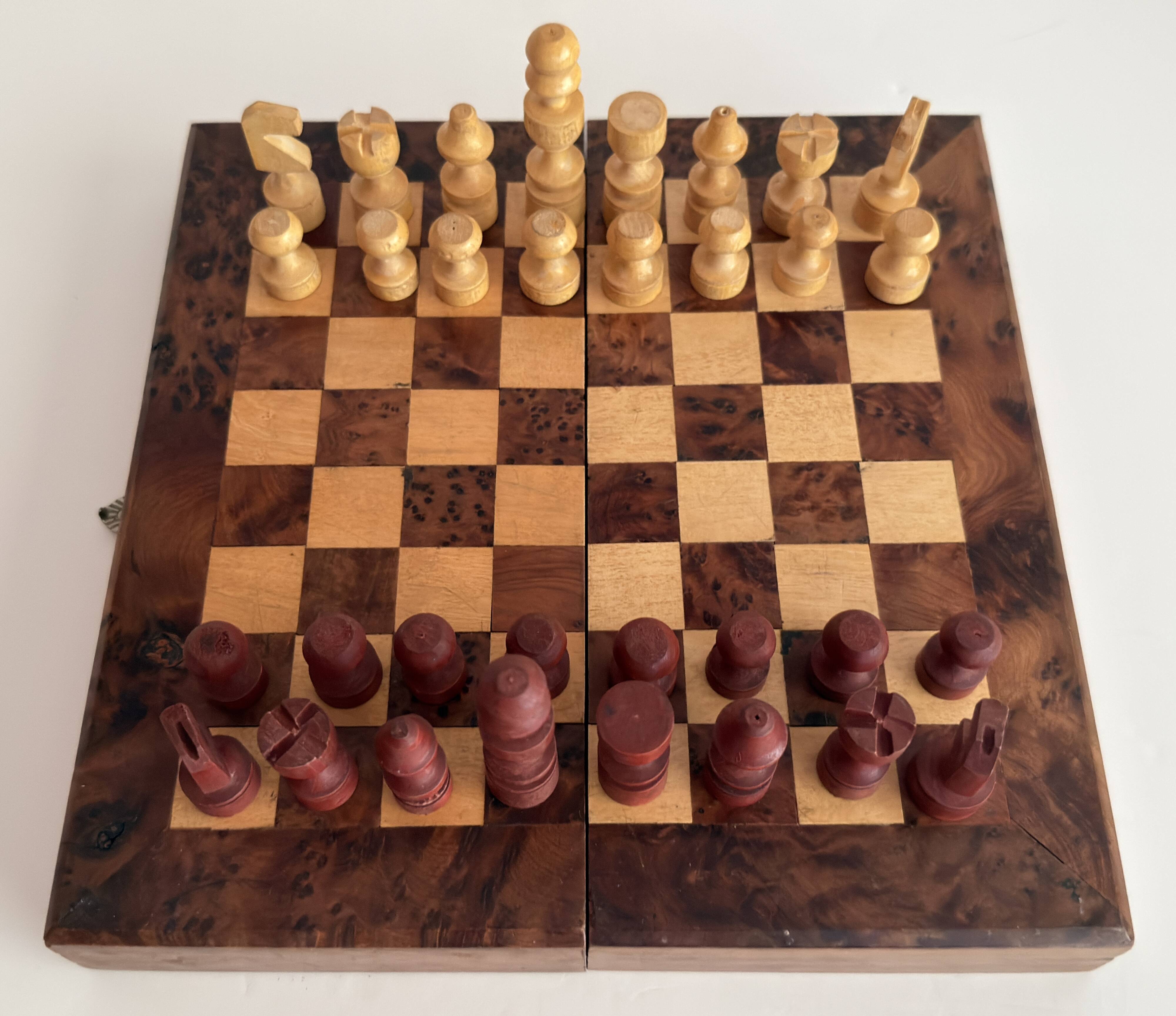 Old wooden chess set with a folding wooden box.